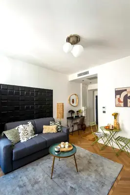 a living room with a blue couch and a table at 302b Beautiful studio refurbished Downtown / Ac in Nice