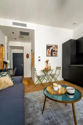 a living room with a blue couch and a table at 302b Beautiful studio refurbished Downtown / Ac in Nice