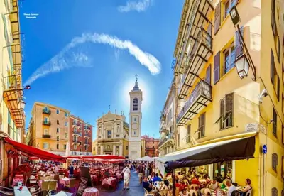 a city street with a clock tower in the distance at Magenta - T2 Au Cœur Du Carré D'or De Nice in Nice