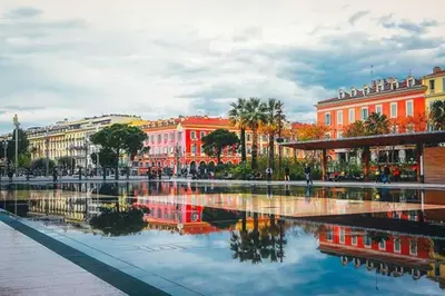 a city with buildings and a reflection in the water at Magenta - T2 Au Cœur Du Carré D'or De Nice in Nice
