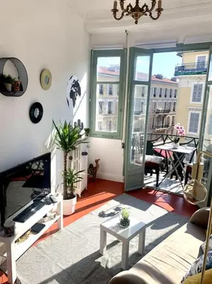 a living room with a couch and a table at Magenta - T2 Au Cœur Du Carré D'or De Nice in Nice