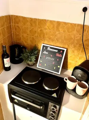a stove top with two pots and a chalk board at Magenta - T2 Au Cœur Du Carré D'or De Nice in Nice