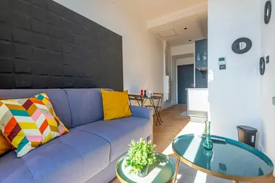 a living room with a blue couch and a table at 304 B Charming apartment refurbished super in Nice