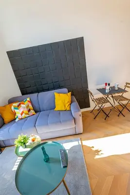 a living room with a blue couch and a table at 304 B Charming apartment refurbished super in Nice