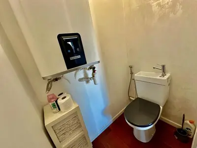 a small bathroom with a toilet and a scale at ⁂ Charmant 2 pièces centre-ville avec parking in Cagnes-sur-Mer