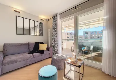 a living room with a couch and a large window at Nestor&Jeeves -PERLE DOREE - Terrace - Design in Nice