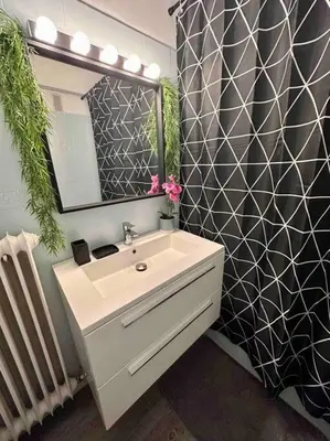 a bathroom with a sink and a mirror at Orangers - Bord de mer - Studio cosy 4 personnes in Cagnes-sur-Mer