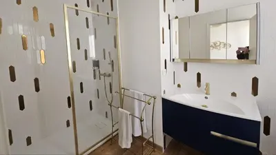 a bathroom with a sink and a mirror at Deux pièces terrasse sous les étoiles in Nice
