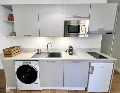 a kitchen with a washing machine and a microwave at Confortable central Studio to discover Nice in Nice