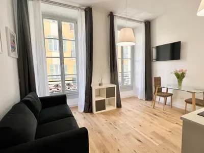 a living room with a couch and a table at Confortable central Studio to discover Nice in Nice