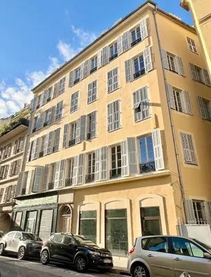 a large yellow building with cars parked in front of it at Confortable central Studio to discover Nice in Nice