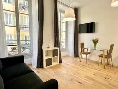 a living room with a couch and a table at Confortable central Studio to discover Nice in Nice