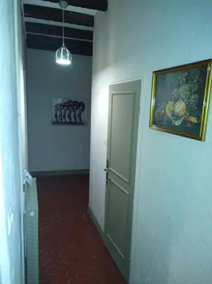 a hallway with a door and a painting on the wall at Heart of Vieux Nice Beach & Saleya in Nice