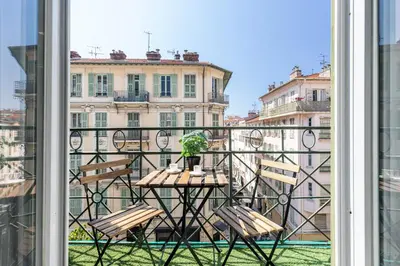a balcony with a table with a plant on it at Studio Duplex Carré d'Or in Nice