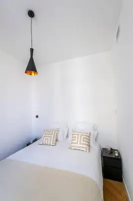 a bedroom with a white bed with two pillows at Elegant T2 rénové 4 Pers, Centre Nice, Climatisé in Nice