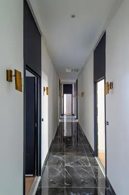 a hallway with black doors and a tile floor at Elegant T2 rénové 4 Pers, Centre Nice, Climatisé in Nice