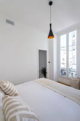 a white bed with a pillow and a window at Elegant T2 rénové 4 Pers, Centre Nice, Climatisé in Nice