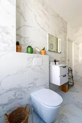 a white bathroom with a toilet and a sink at Elegant T2 rénové 4 Pers, Centre Nice, Climatisé in Nice