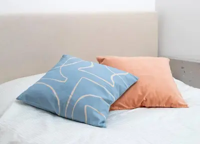 a bed with a blue pillow and an orange pillow at Unique Old Town Designer Studio in Nice