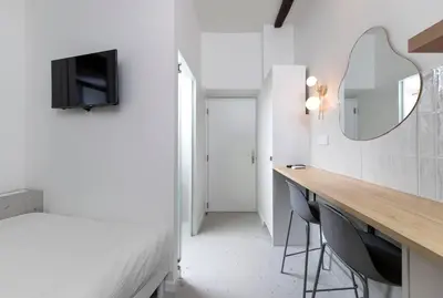 a bedroom with a desk and a mirror and a bed at Unique Old Town Designer Studio in Nice