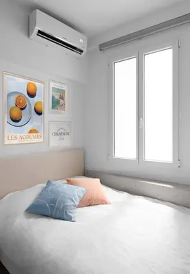 a bedroom with a large white bed with a window at Unique Old Town Designer Studio in Nice