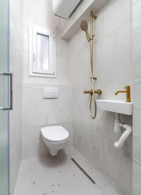 a white bathroom with a toilet and a sink at Unique Old Town Designer Studio in Nice