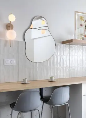 a table with two chairs and a large light fixture at Unique Old Town Designer Studio in Nice