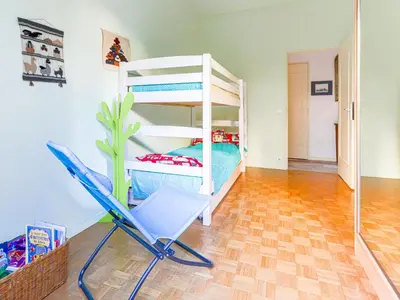 a room with a bunk bed and a chair at Apartment Terrasses de la Baie des Anges by Interhome in Nice