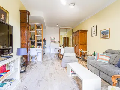 a living room with a couch and a tv at Apartment Terrasses de la Baie des Anges by Interhome in Nice