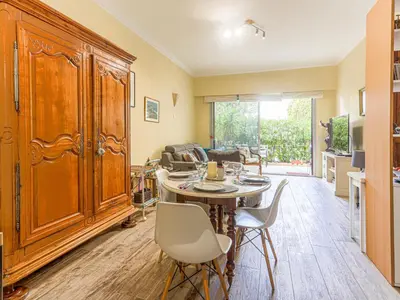 a living room with a table and some chairs at Apartment Terrasses de la Baie des Anges by Interhome in Nice