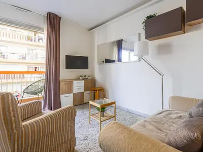 a living room with two couches and a tv at Apartment Les Arènes de Cimiez-1 by Interhome in Nice