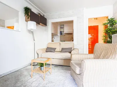 a living room with two couches and a table at Apartment Les Arènes de Cimiez-1 by Interhome in Nice