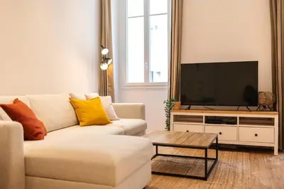 a living room with a couch and a flat screen tv at Magnifique 2P avec vue sur le port de Nice in Nice