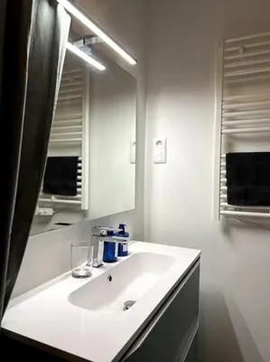 a white bathroom with a sink and a mirror at EZE Roc (Monaco) in Èze