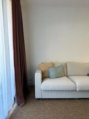 a white couch sitting in a living room next to a window at EZE Roc (Monaco) in Èze