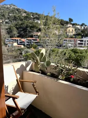 a balcony with a stuffed rabbit sitting on a ledge at EZE Roc (Monaco) in Èze