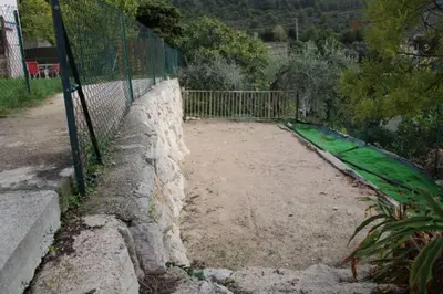 a road with a fence and a stone wall at Location 2 pièces sur EZE à 3km de MONACO (2) in Èze