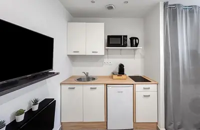 a small kitchen with a sink and a microwave at Studio Centre Ville proche TRAM & Port, Wifi Gratuit in Nice