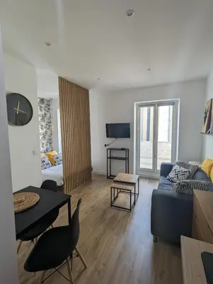 a living room with a couch and a table at appartement carré d'or in Nice