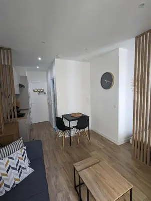 a living room with a couch and a table at appartement carré d'or in Nice