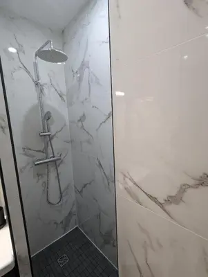 a bathroom with a shower with a glass door at appartement carré d'or in Nice