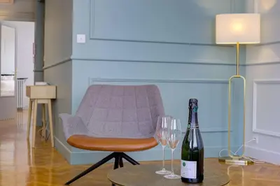 a bottle of wine and two wine glasses on a table at Luxury apartment in City Center of Nice in Nice