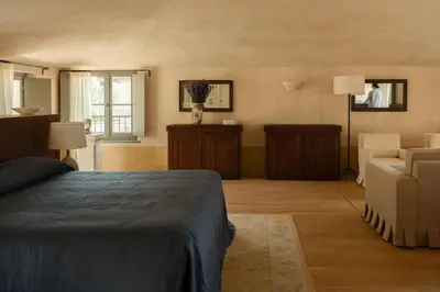 a living room with a table and a chair and a window at Hôtel du Couvent, a Luxury Collection Hotel, Nice in Nice