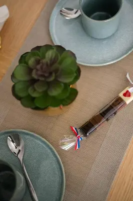 a table with two plates and a cup and a plant at App-Art in Nice