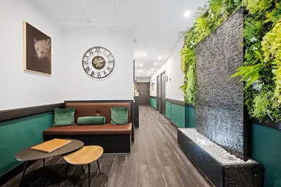 a waiting room with a plant wall at App-Art in Nice