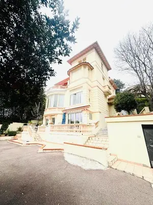 a large white house with stairs in front of it at Villa Reine - Nice in Nice