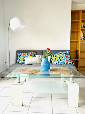 a living room with a couch and a glass table at Villa Reine - Nice in Nice