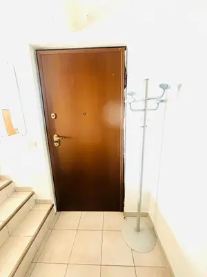 a brown door in a room with stairs at Villa Reine - Nice in Nice