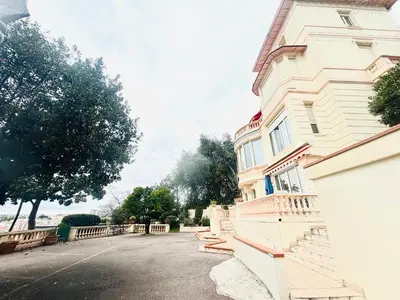 a building with a bench on the side of it at Villa Reine - Nice in Nice