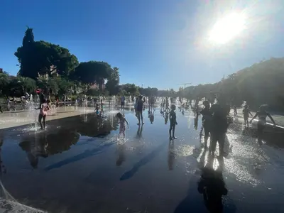 a group of people playing in a fountain at Villa Reine - Nice in Nice